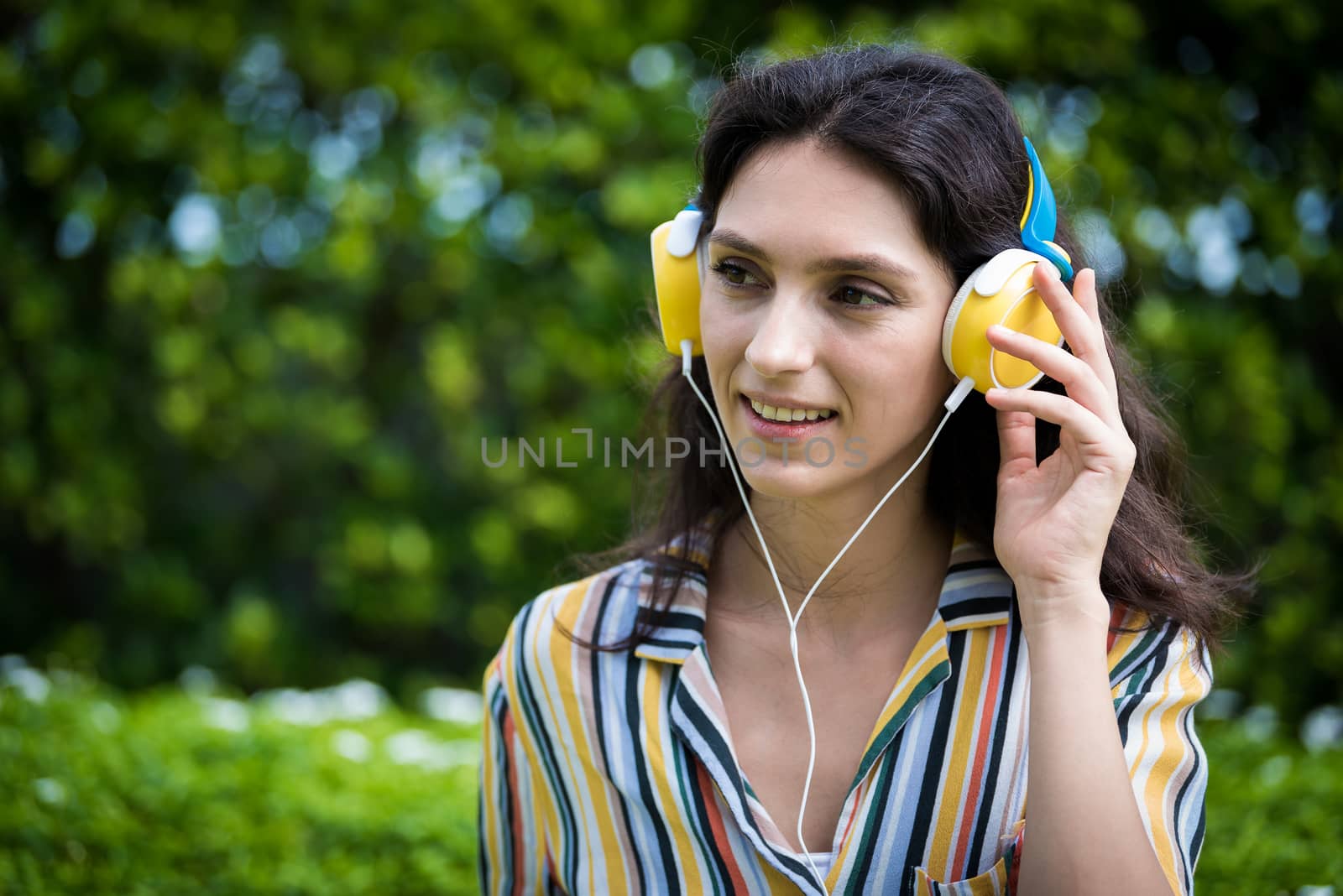 Portrait of a beautiful woman has listening to music with smilin by animagesdesign