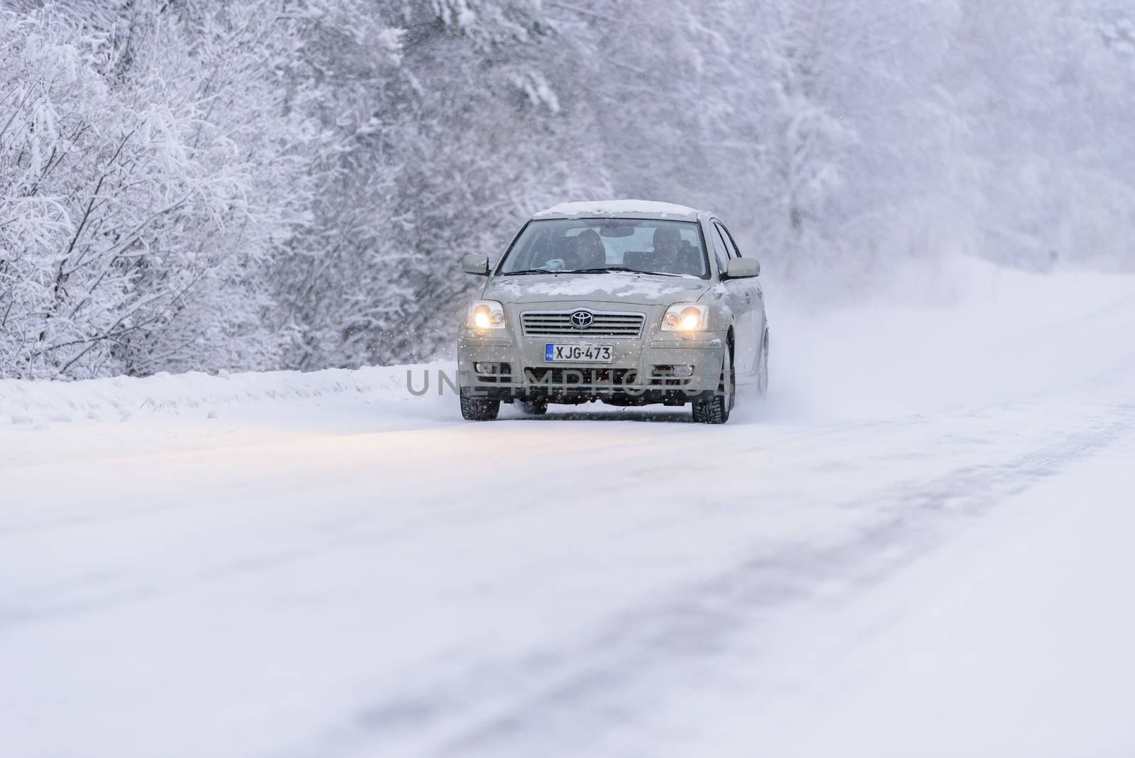 Editorial: Tuupovaara City, Finland, 25th December 2018. Toyota car on the road number 496 with heavy snow in winter season at Tuupovaara, Finland.