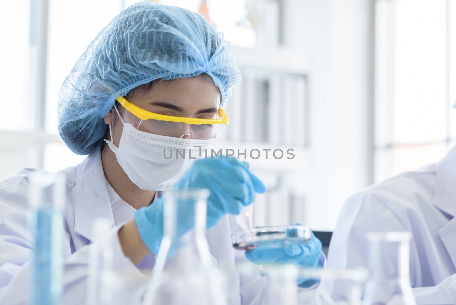 Asian young girl student scientist researching  and learning in a laboratory.