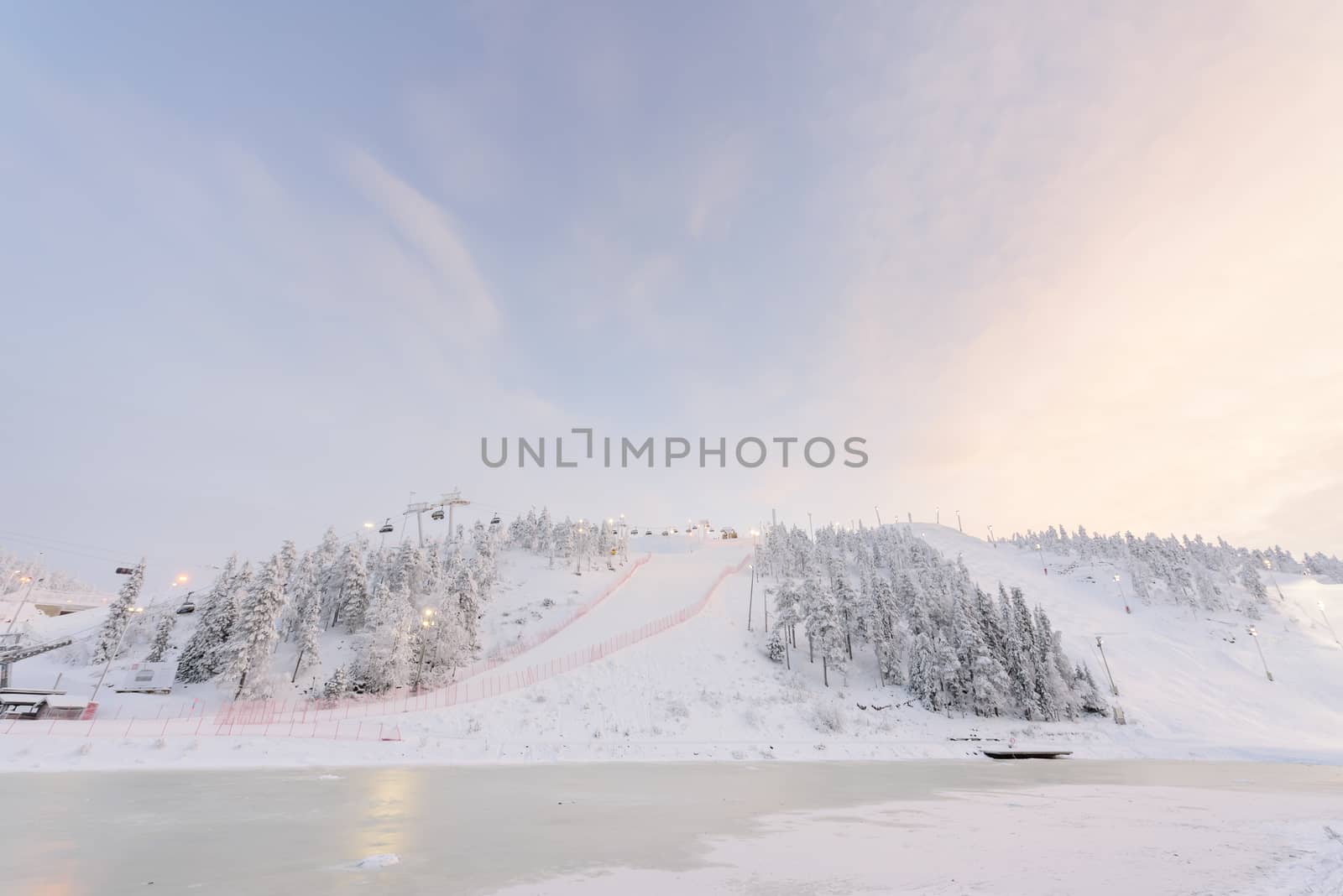 Rukatunturi ski jumping hill in winter season and nice weather and blue sky in winter season and sunset time at Ruka ski Rukatunturi, Finland