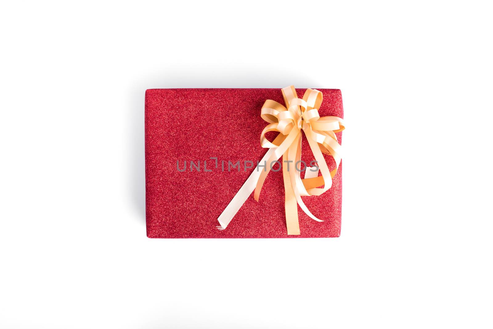 The Christmas present with red glitter gift wrapping and gold ribbon isolated on white background.