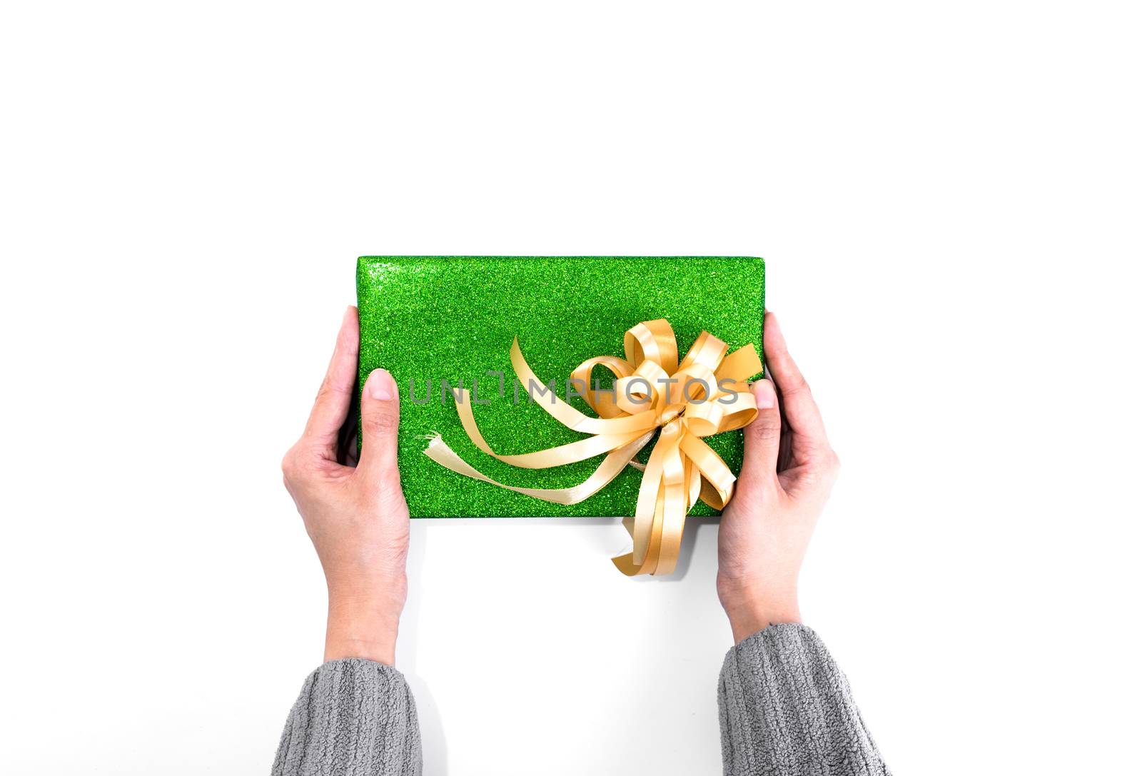 Holding Christmas present with green glitter wrapping paper and  by animagesdesign