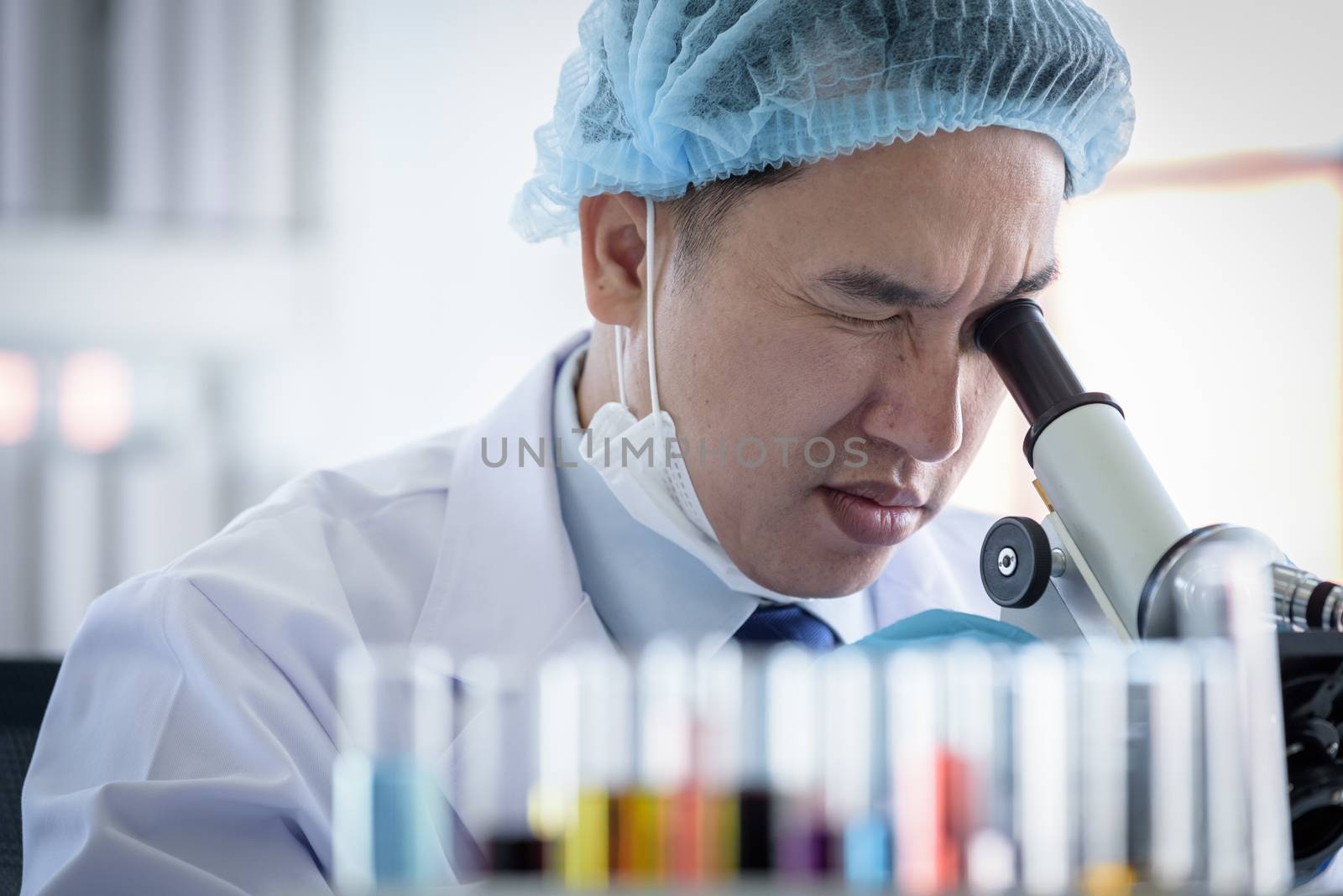 Asian man scientist researching  and learning in a laboratory.