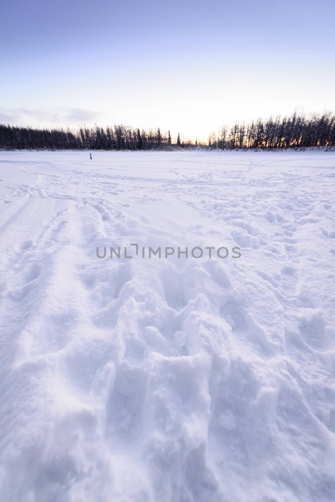 The ice lake and forest has covered with heavy snow and nice blu by animagesdesign