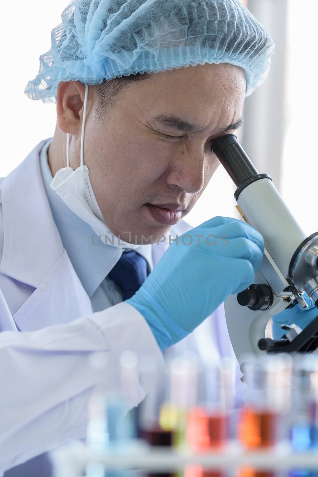 Asian man scientist researching  and learning in a laboratory. by animagesdesign