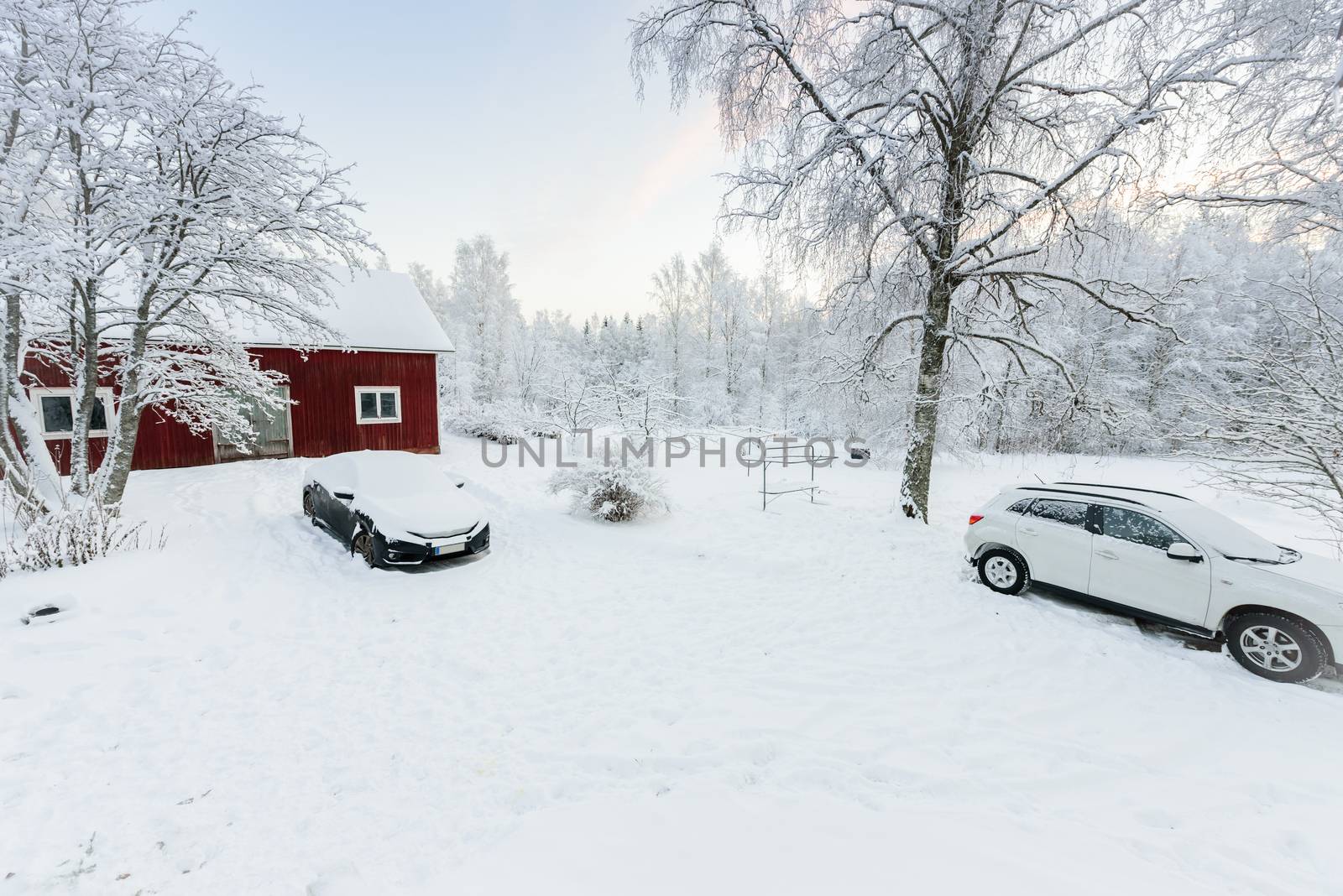 The house and car in the forest has covered with heavy snow and clear blue sky in winter season at Lapland, Finland.