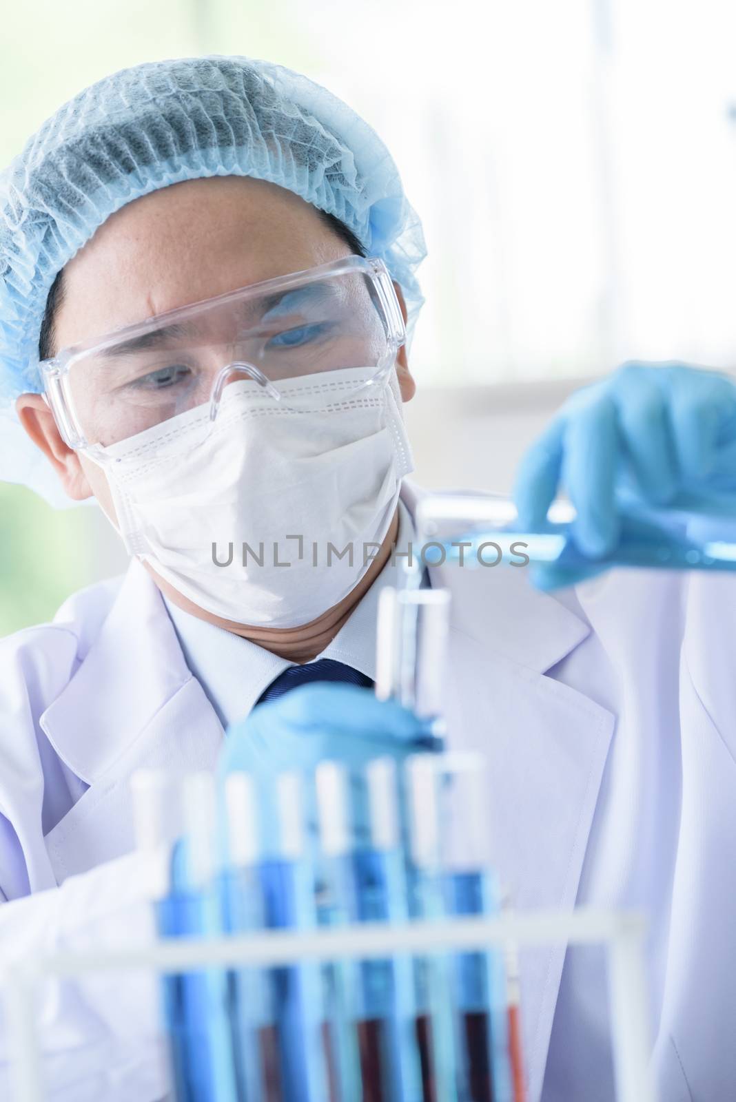 Asian man scientist researching  and learning in a laboratory.