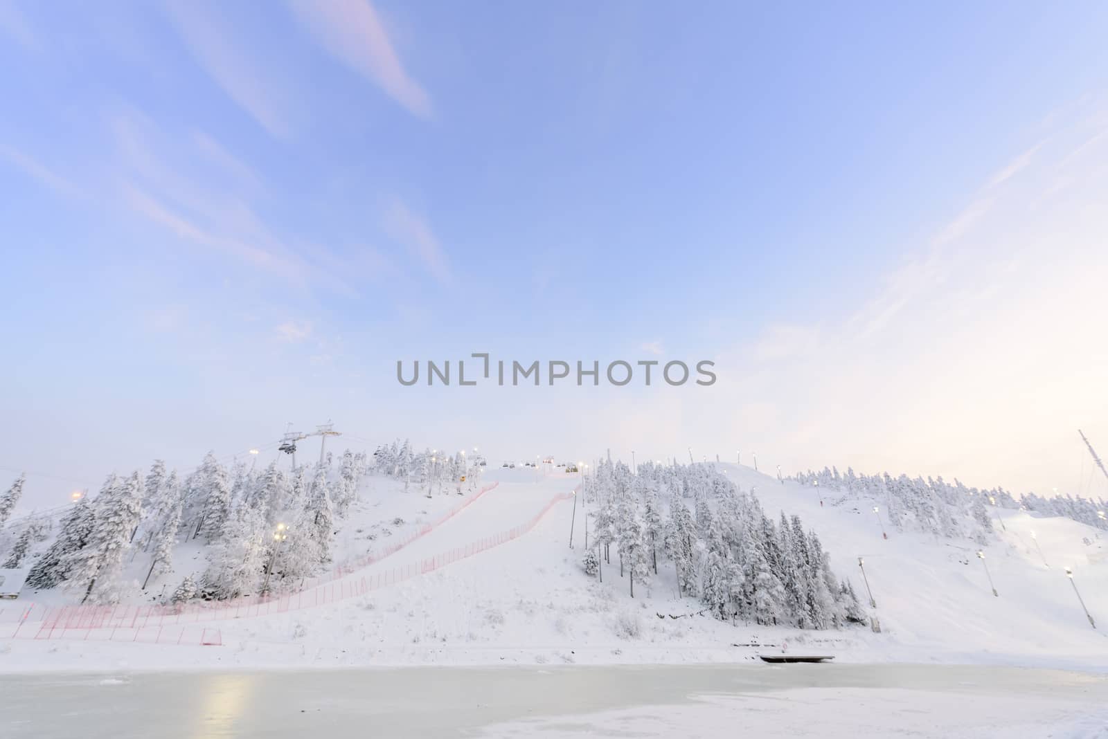 Rukatunturi ski jumping hill in winter season and nice weather and blue sky in winter season and sunset time at Ruka ski Rukatunturi, Finland