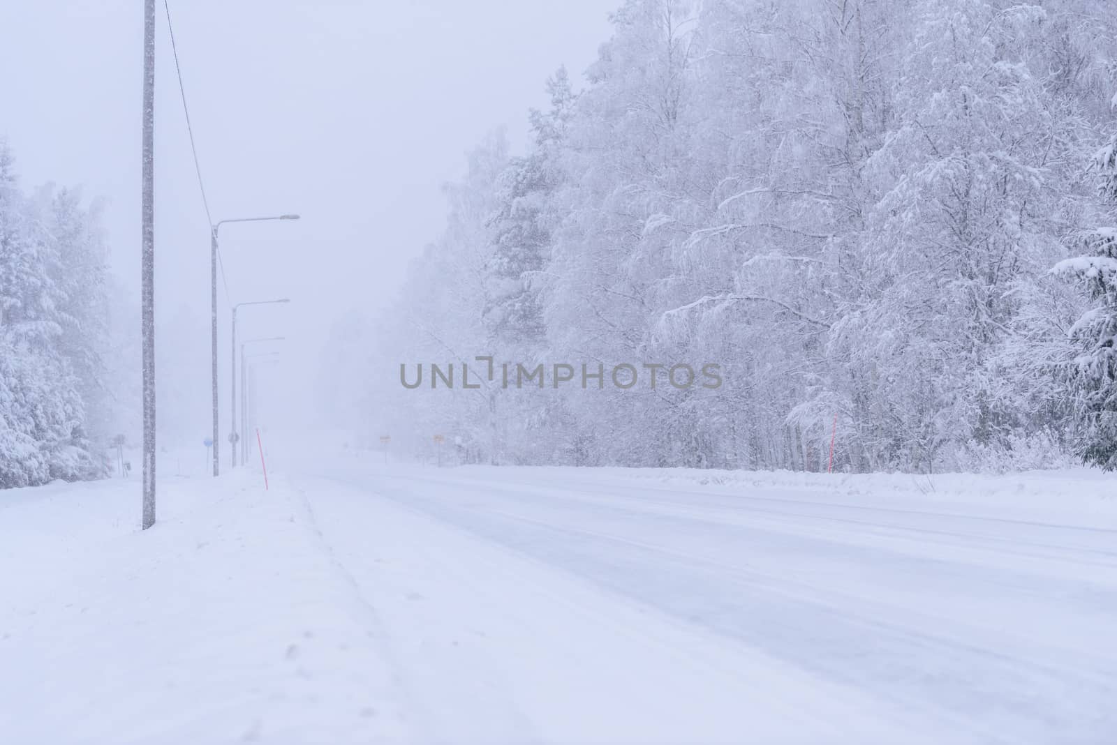 The road number 496  has covered with heavy snow and bad weather by animagesdesign