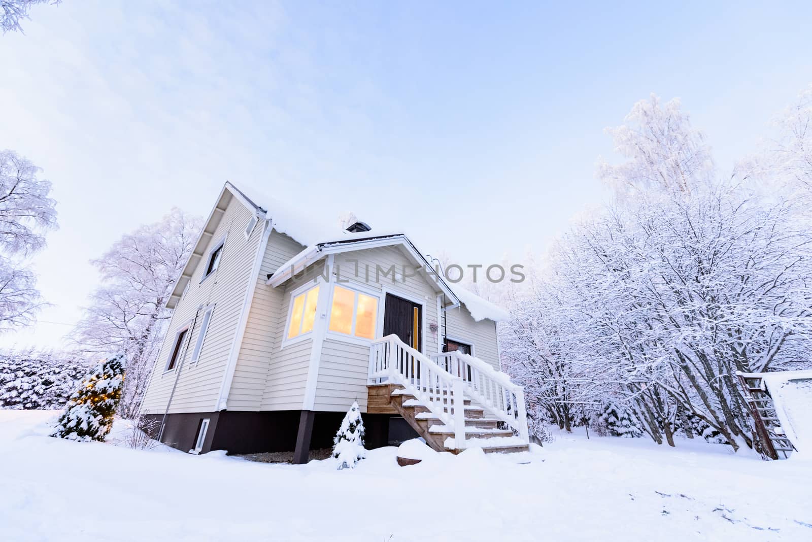 The house in the forest has covered with heavy snow in winter season at Lapland, Finland.