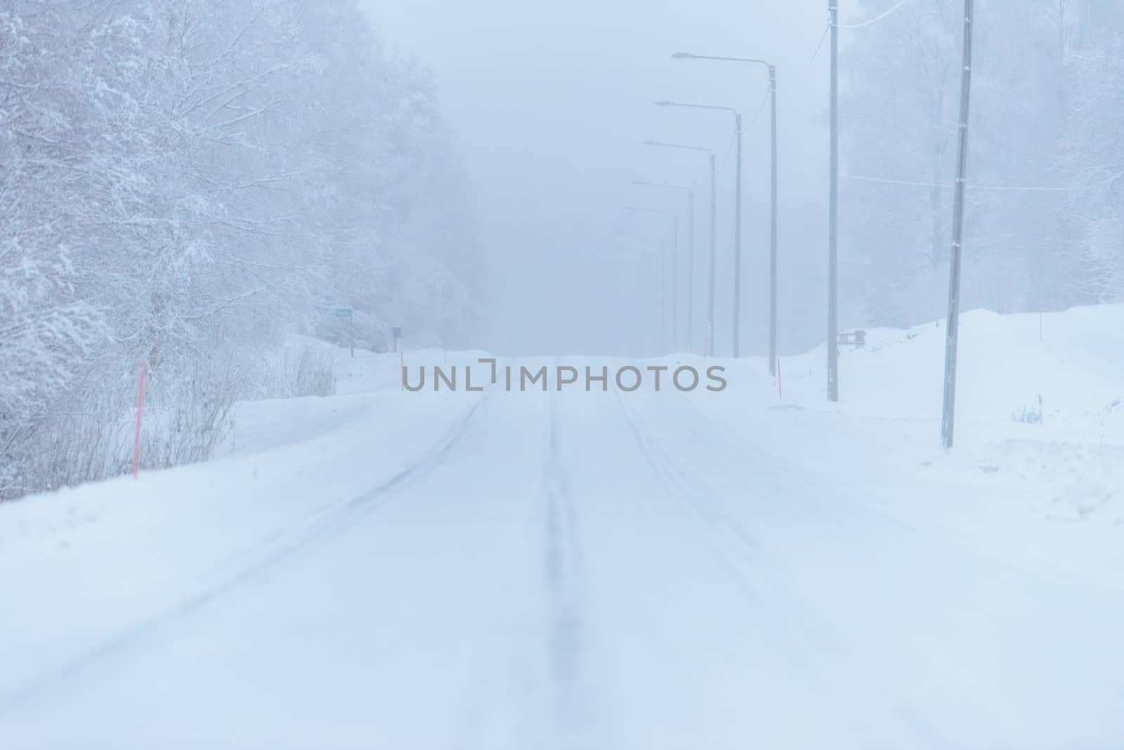 The road number 496  has covered with heavy snow and bad weather in winter season at Tuupovaara, Finland.