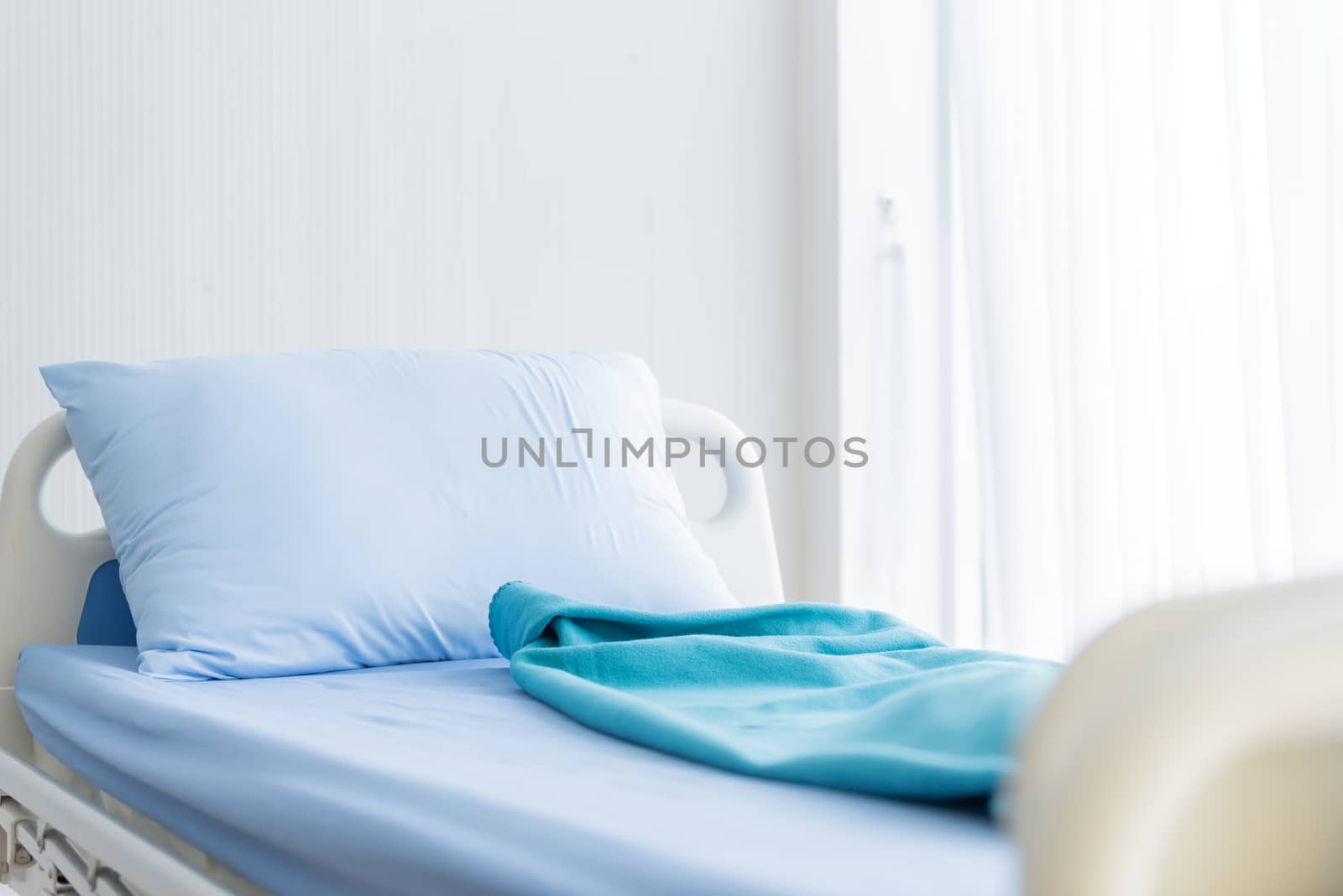 The patient blue bed with bed sheet in the hospital.