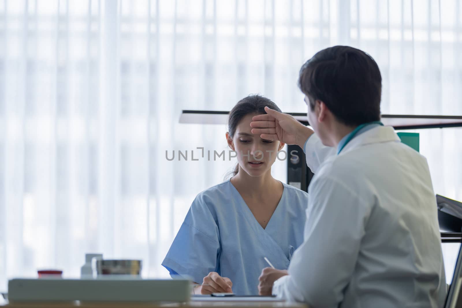 A doctor take care of sick patient woman at the hospital or medical clinic.