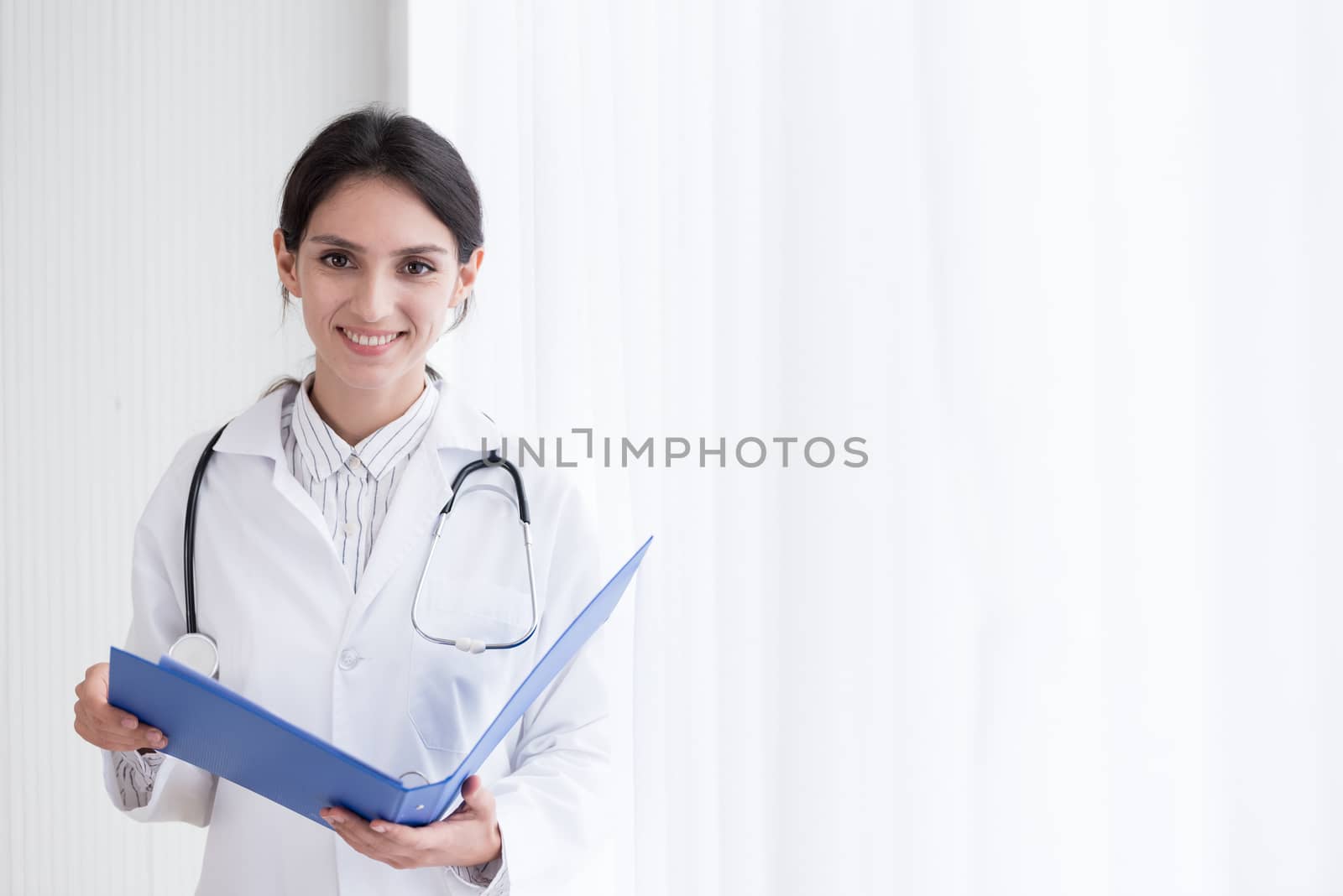 A doctor woman has to work with reading the report at the hospit by animagesdesign