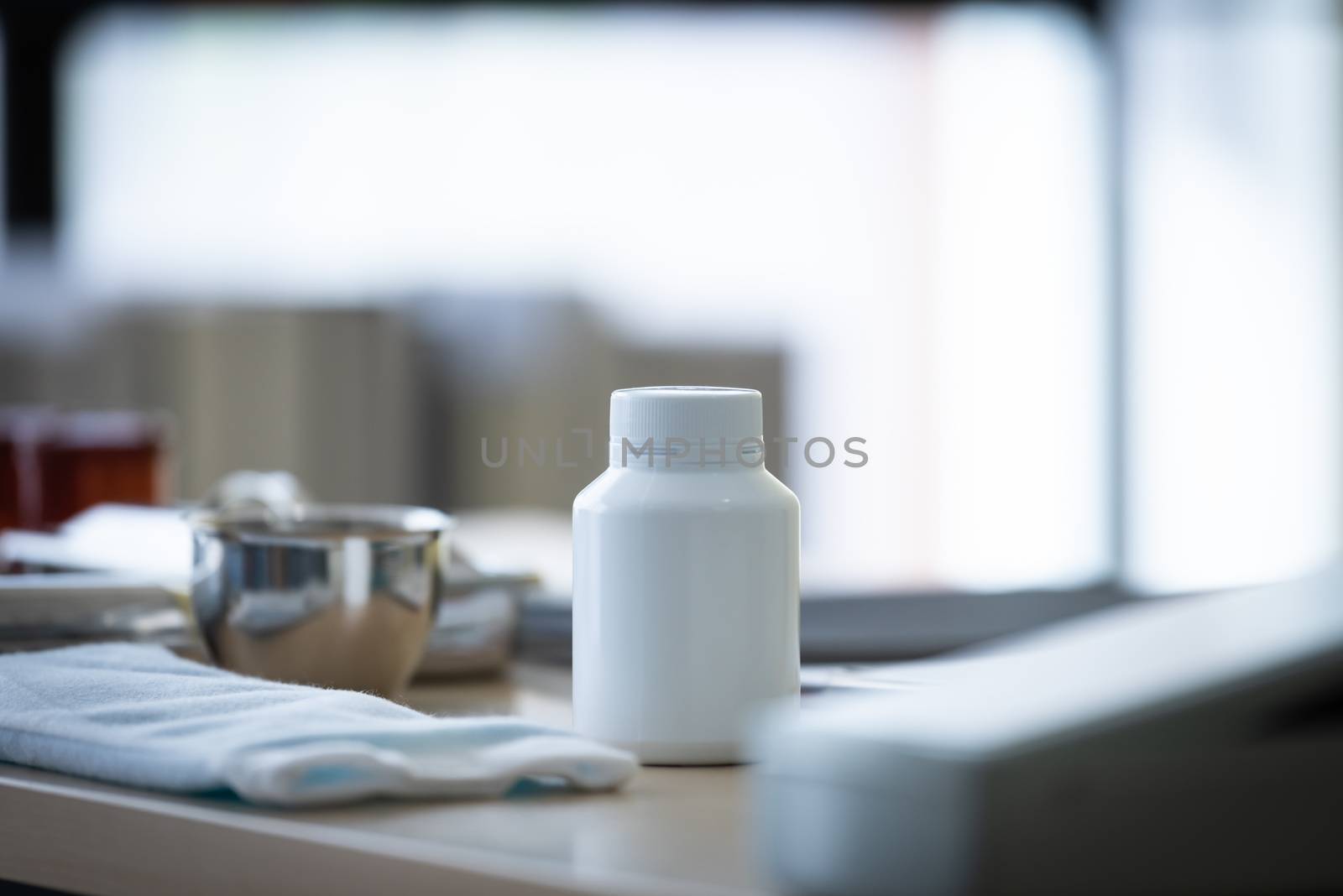 A white medicine bottle on the table. by animagesdesign