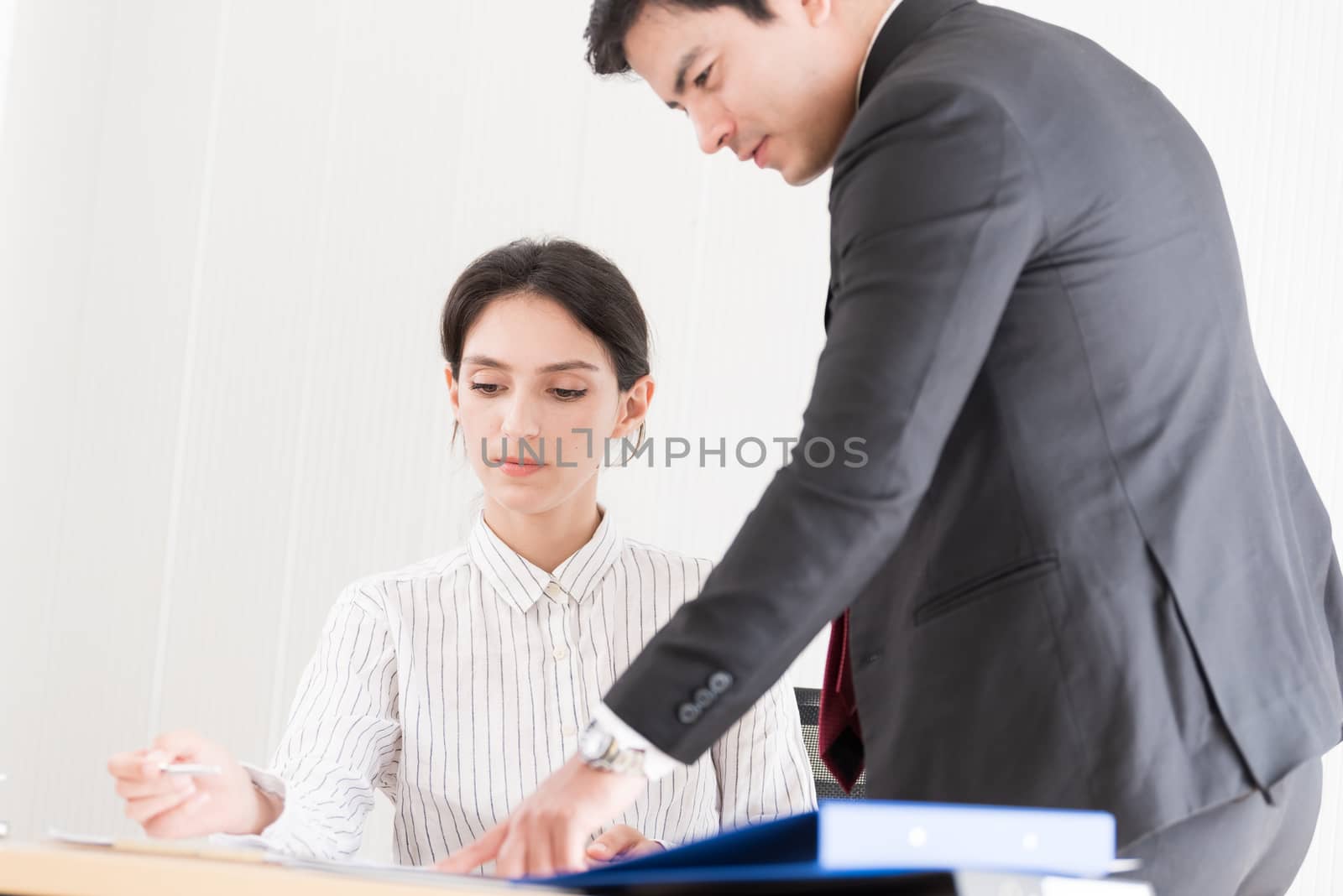 A manager and secretary working together in the office.