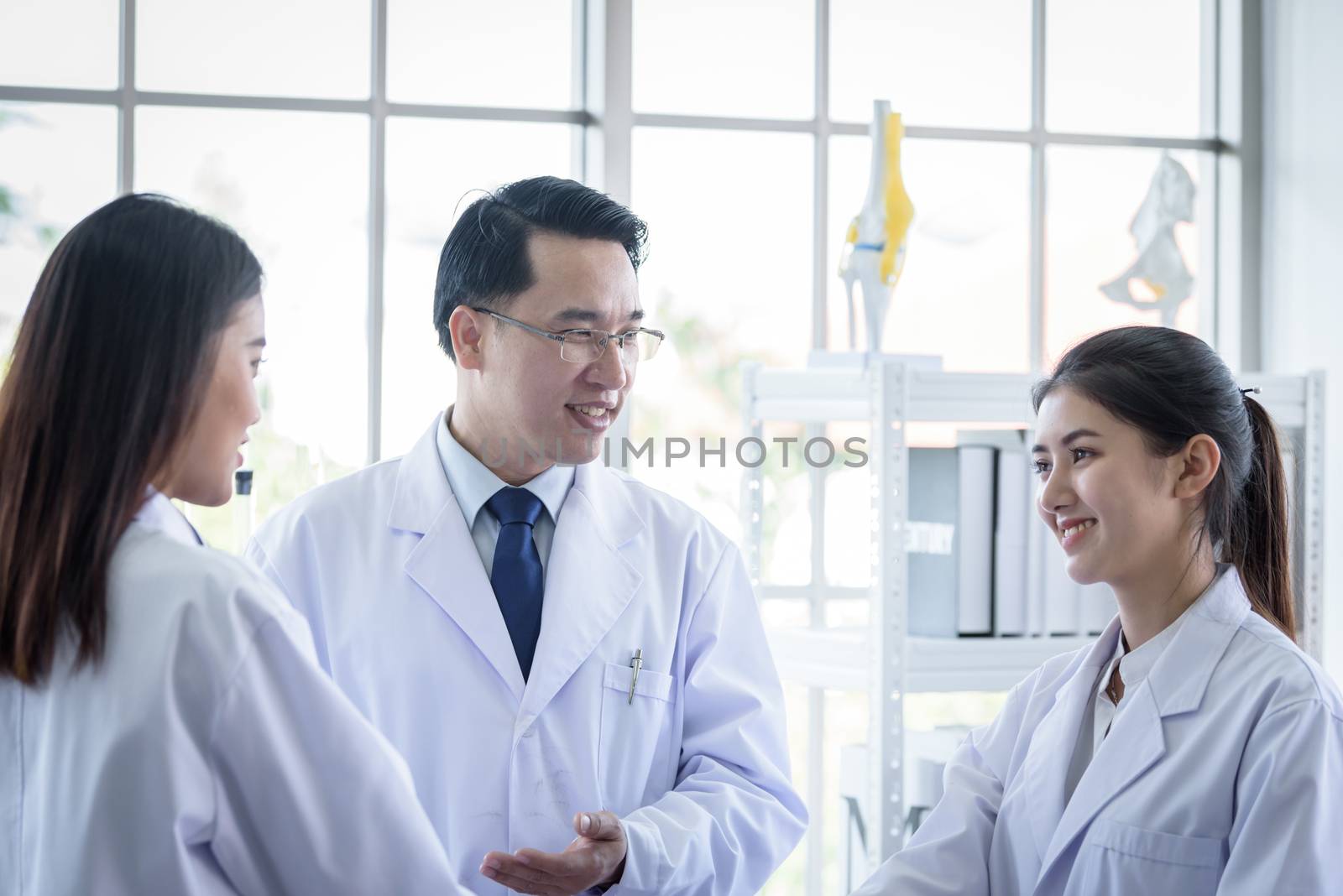 Asian scientist team have meeting in laboratory.