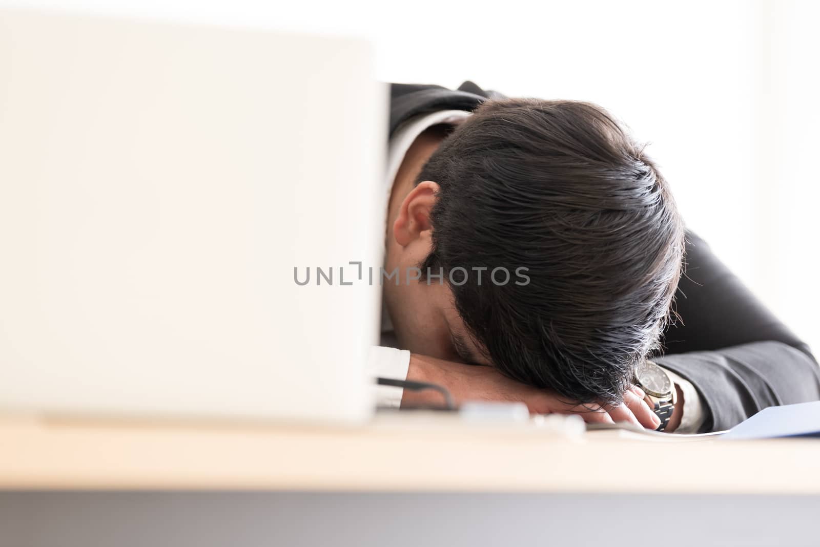 A businessman slept in the working time at the office.