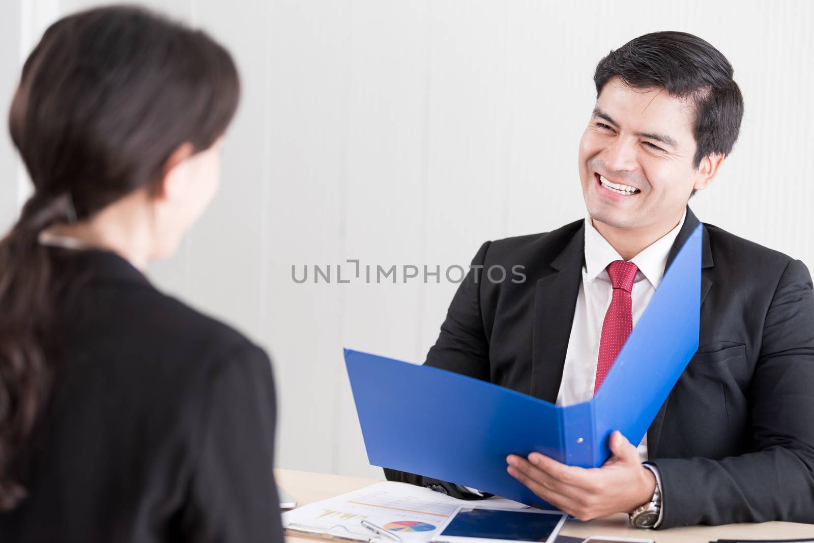 A businessman listens and talking to candidate woman answers for by animagesdesign
