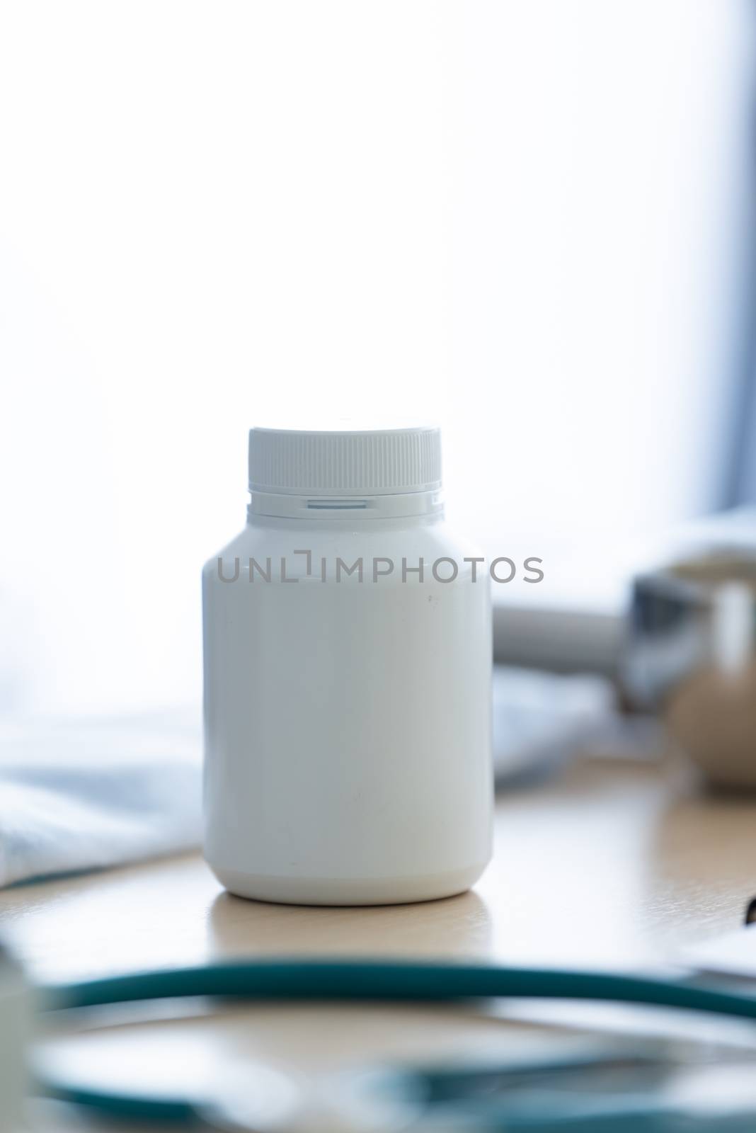 A white medicine bottle on the table.
