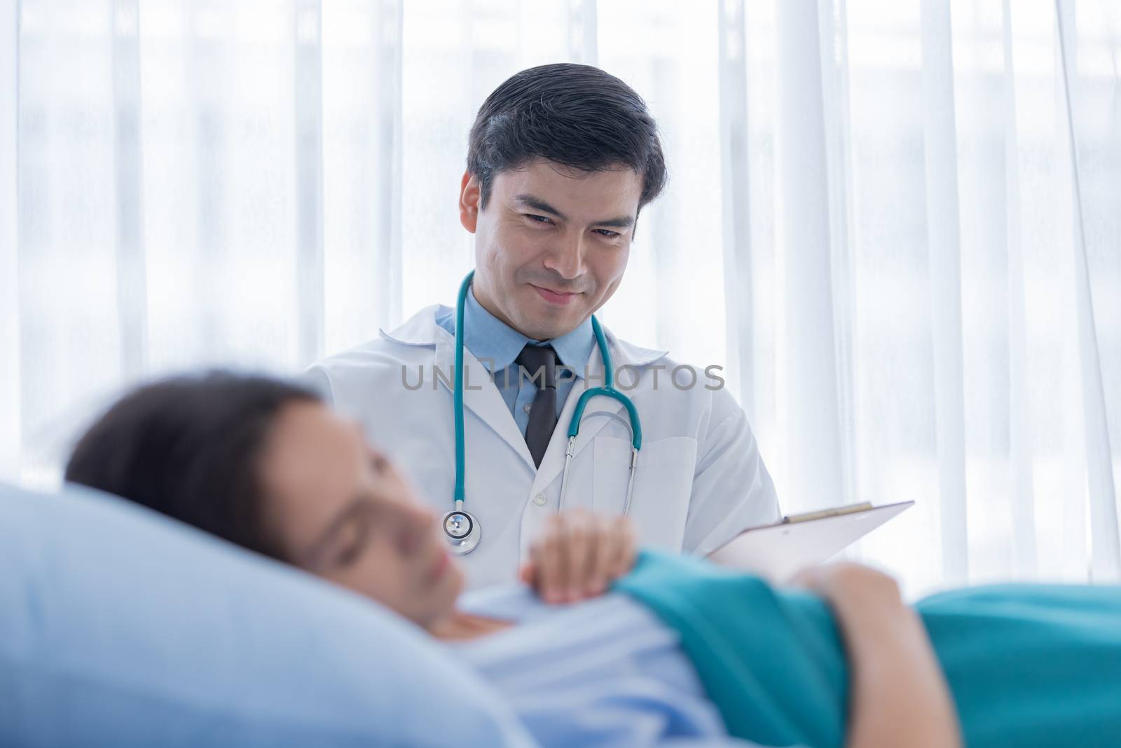 A doctor take care of sick patient woman at the hospital or medical clinic.
