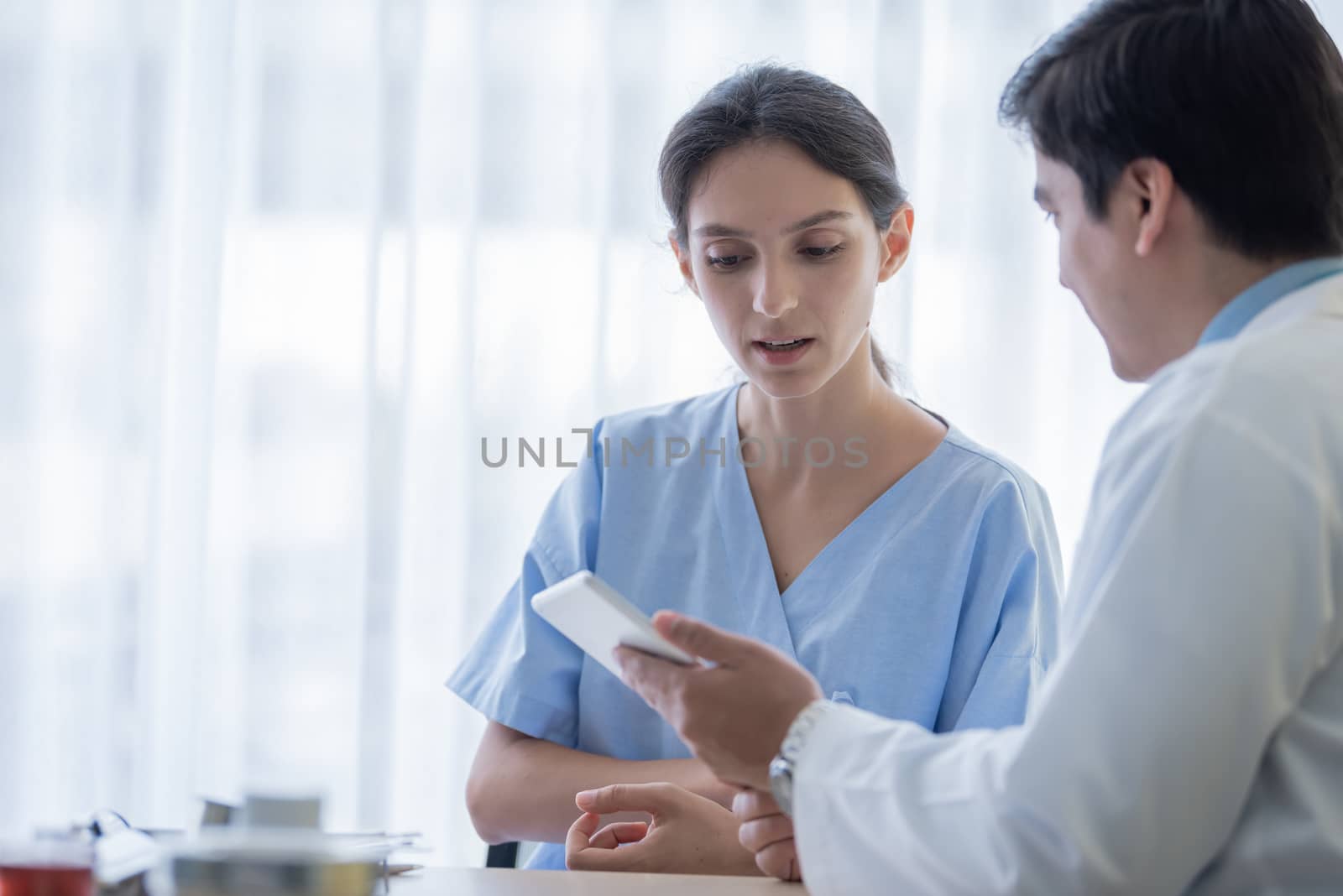 A doctor take care of sick patient woman at the hospital or medical clinic.