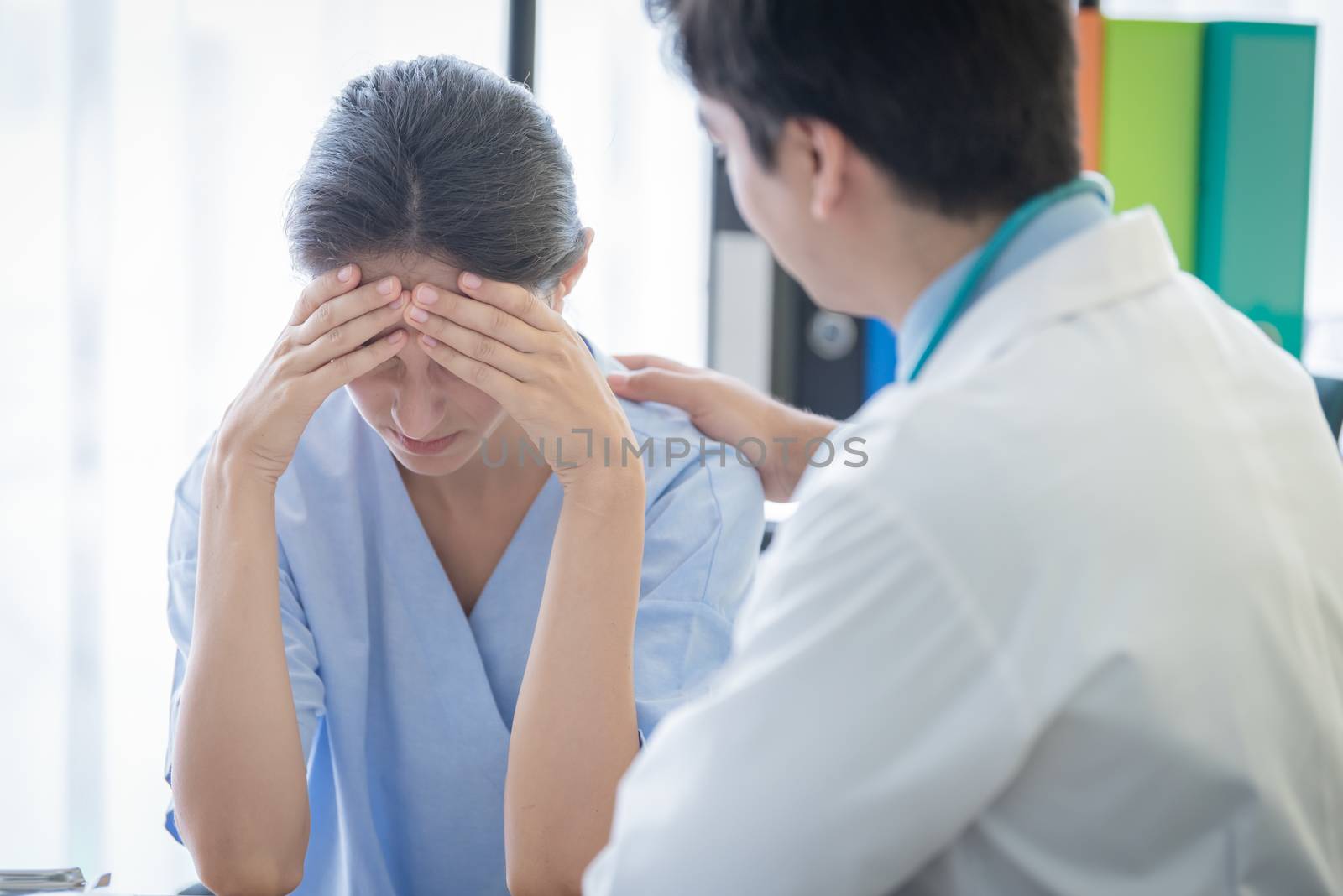 A doctor takes care of a sick patient woman with sadness and unhappiness at the hospital or medical clinic.