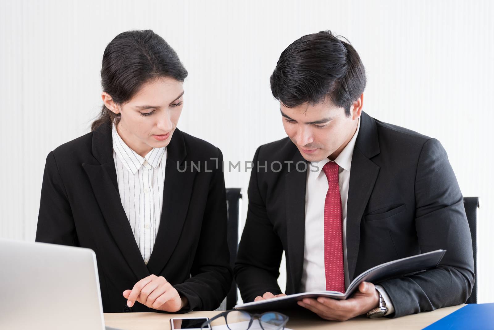 A manager and secretary working together in the office.