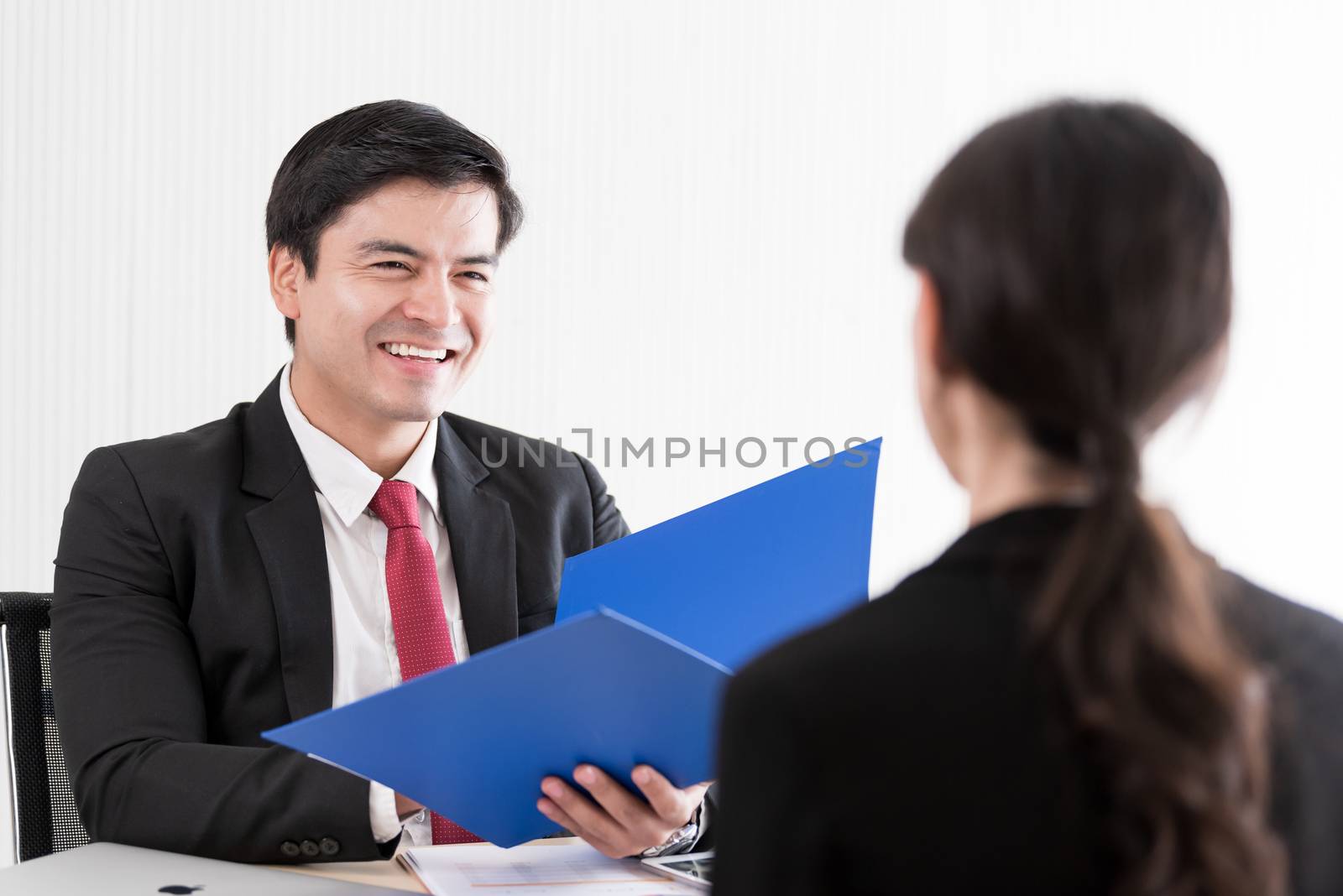 A businessman listens and talking to candidate woman answers for a job interview.