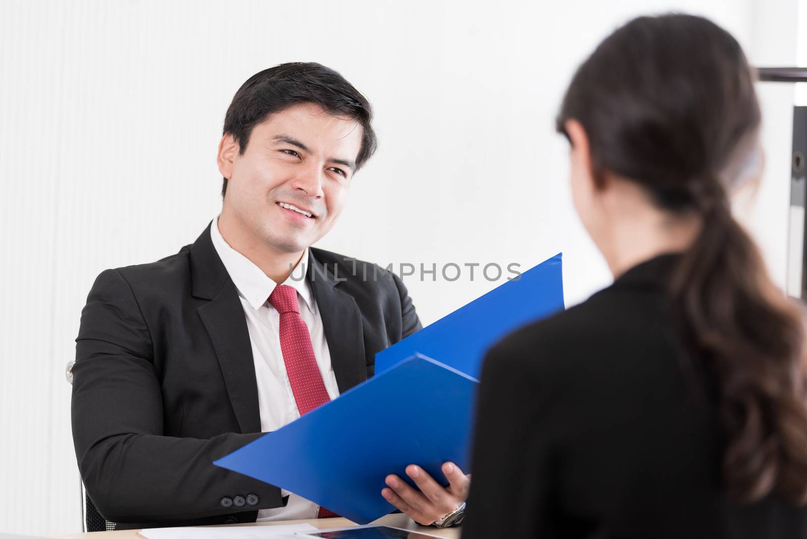 A businessman listens and talking to candidate woman answers for a job interview.