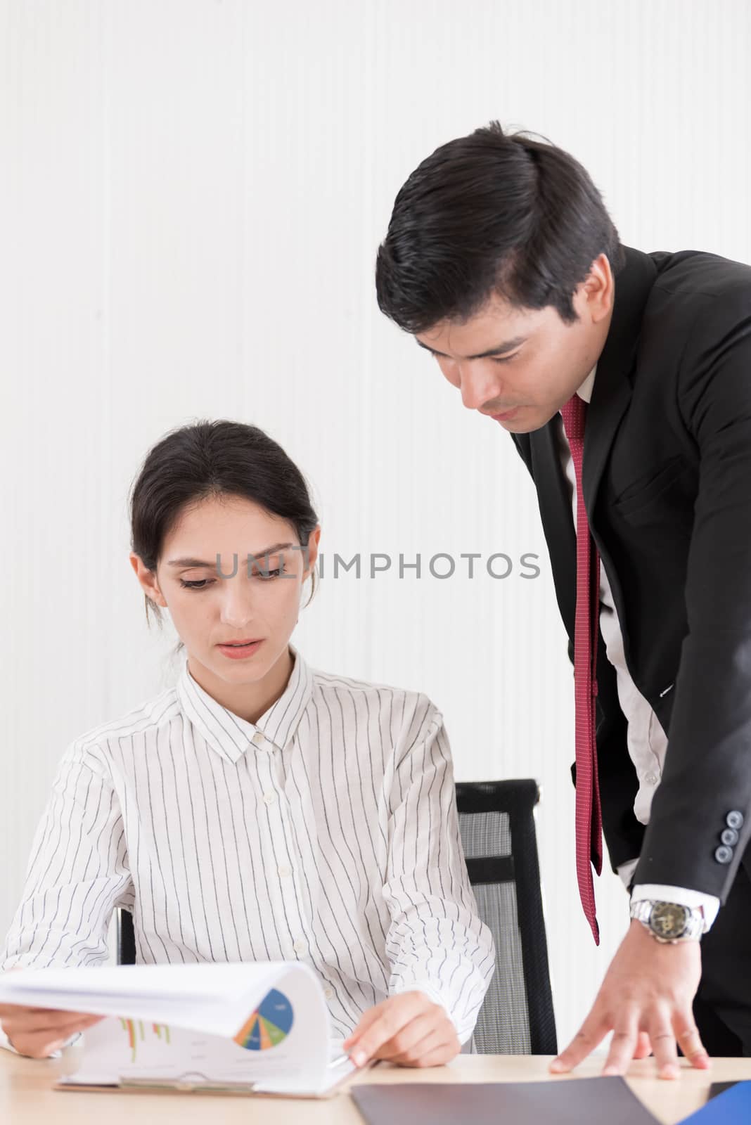 A manager and secretary working together in the office.