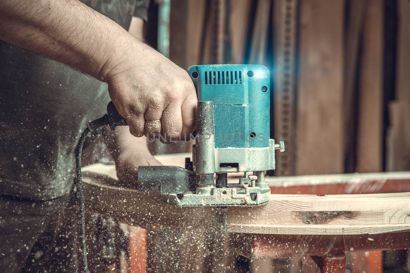 wood milling with electric cutter in joinery. color toning