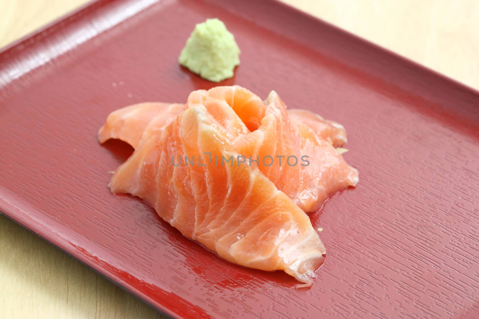 salmon sashimi in wood background by piyato