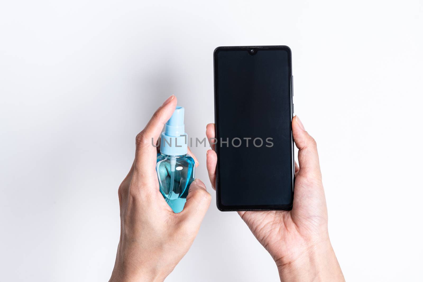 The Asian girl has cleaning the mobile by hand cleaner gel to protect COVID-19 with isolated on white background concept.
