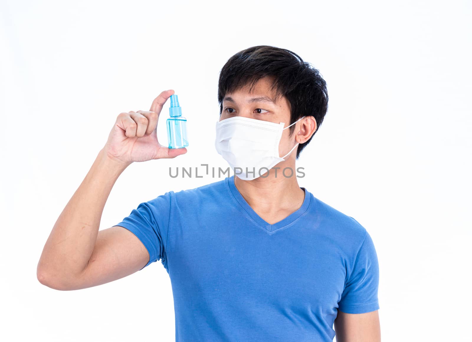 Asian young man in blue t-shirt top with medical mask and hand cleanser gel to protect COVID-19 with isolated on white background concept.
