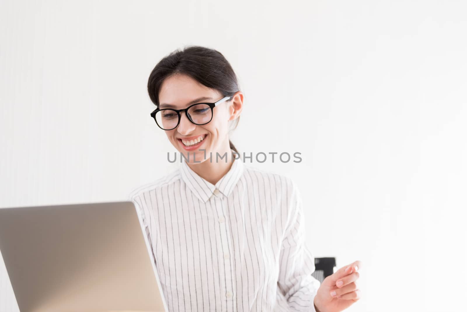 A businesswoman wearing glasses working with smiling and happiness at the office.