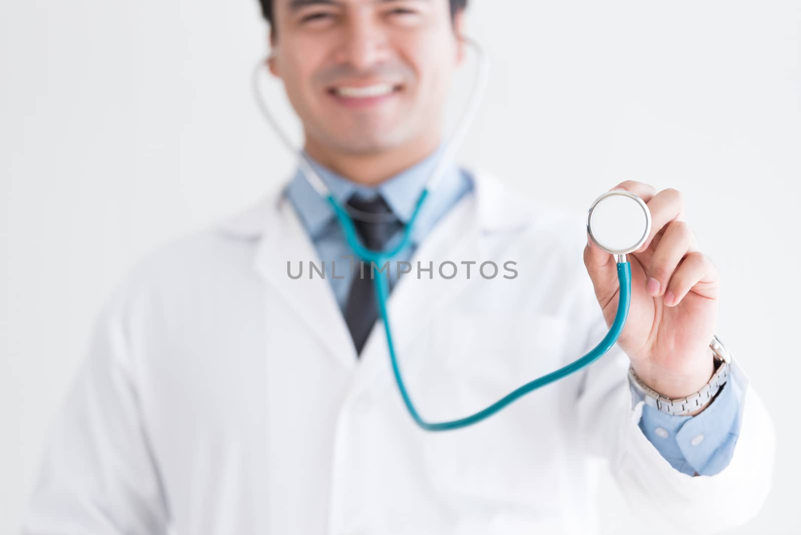A senior doctor isolated has holding the stethoscope on white background.