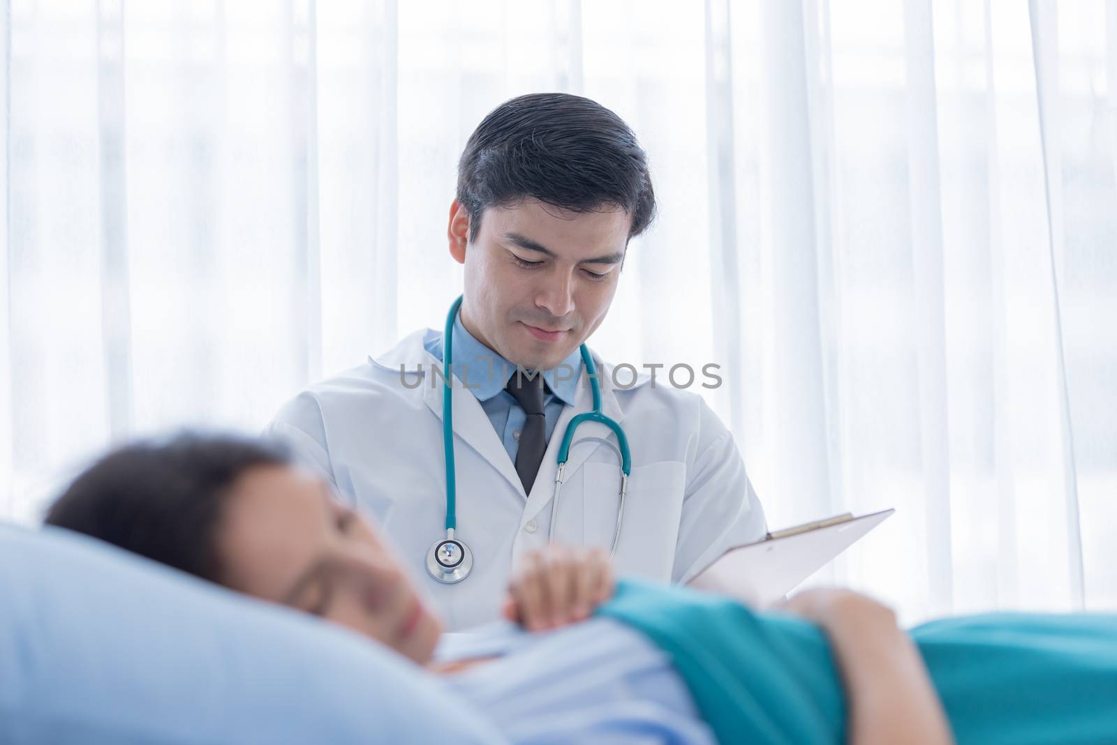 A doctor take care of sick patient woman at the hospital or medi by animagesdesign