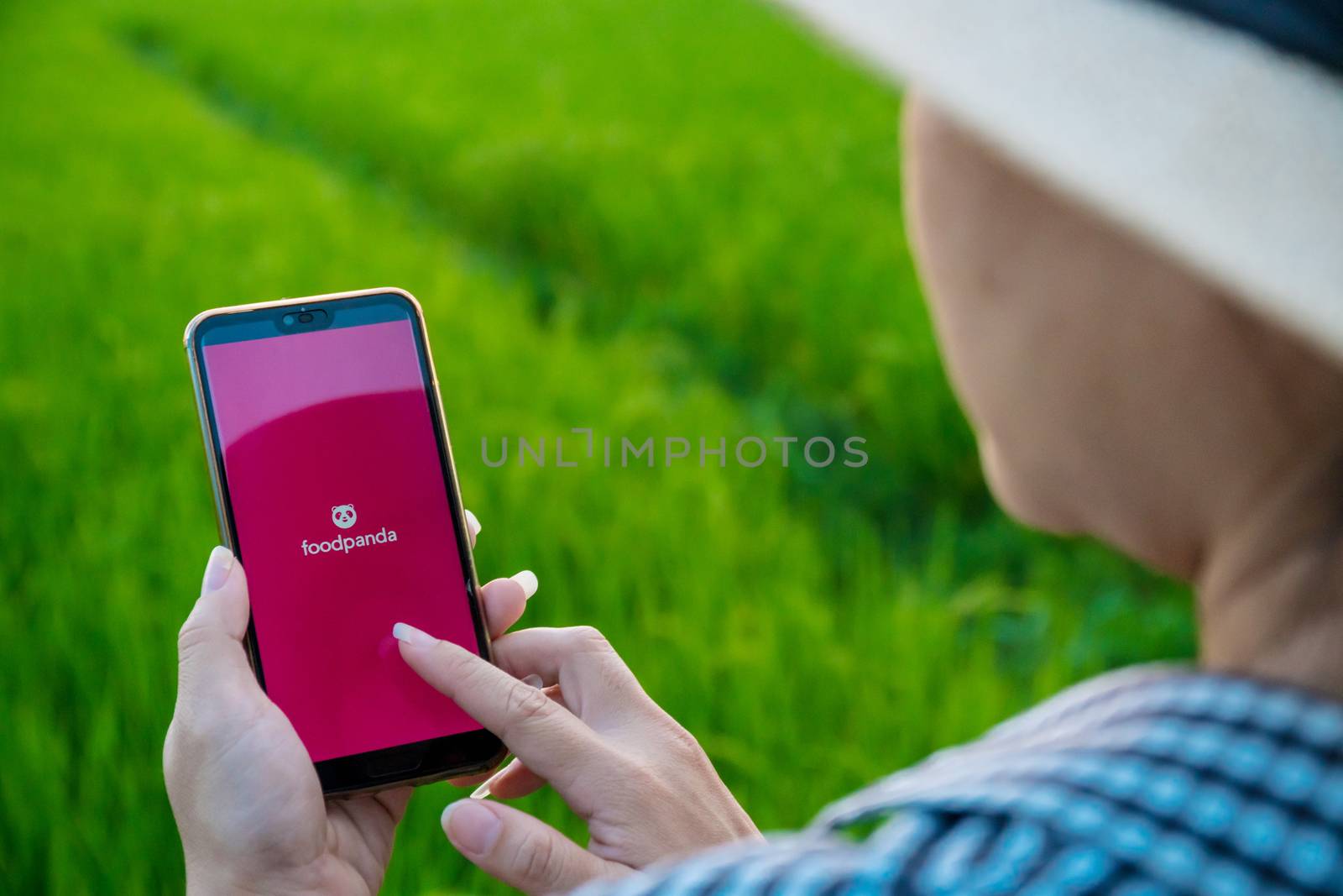 Chiang mai, Thailand - October 16, 2019: Rural women are using the Foodpanda application when she is in the fields