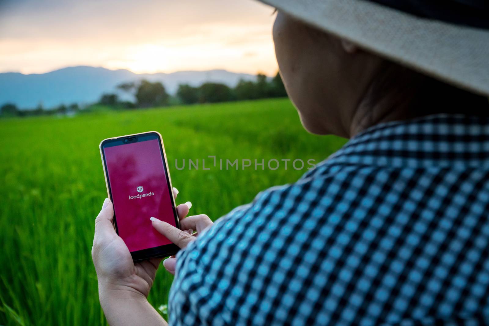 Chiang mai, Thailand - October 16, 2019: Rural women are using the Foodpanda application when she is in the fields