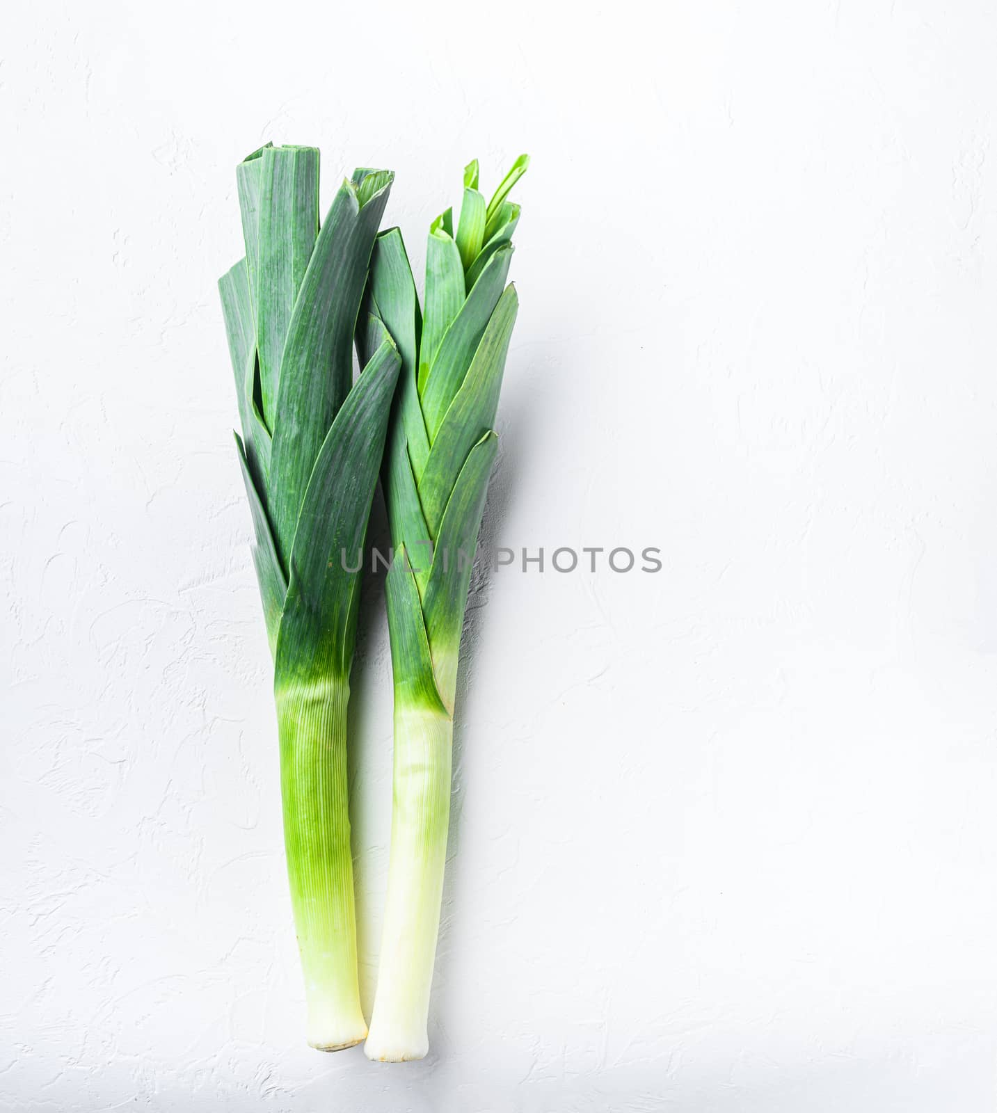 Green leek sultan onion on white table, top view