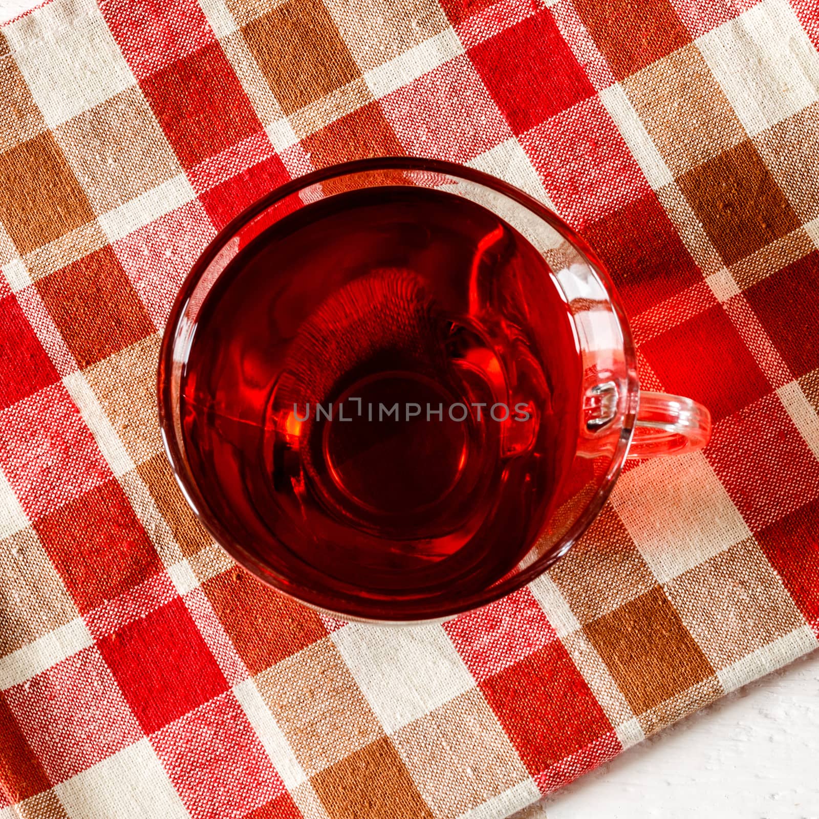 Cup of Karkadeh Red Tea on a white wooden table