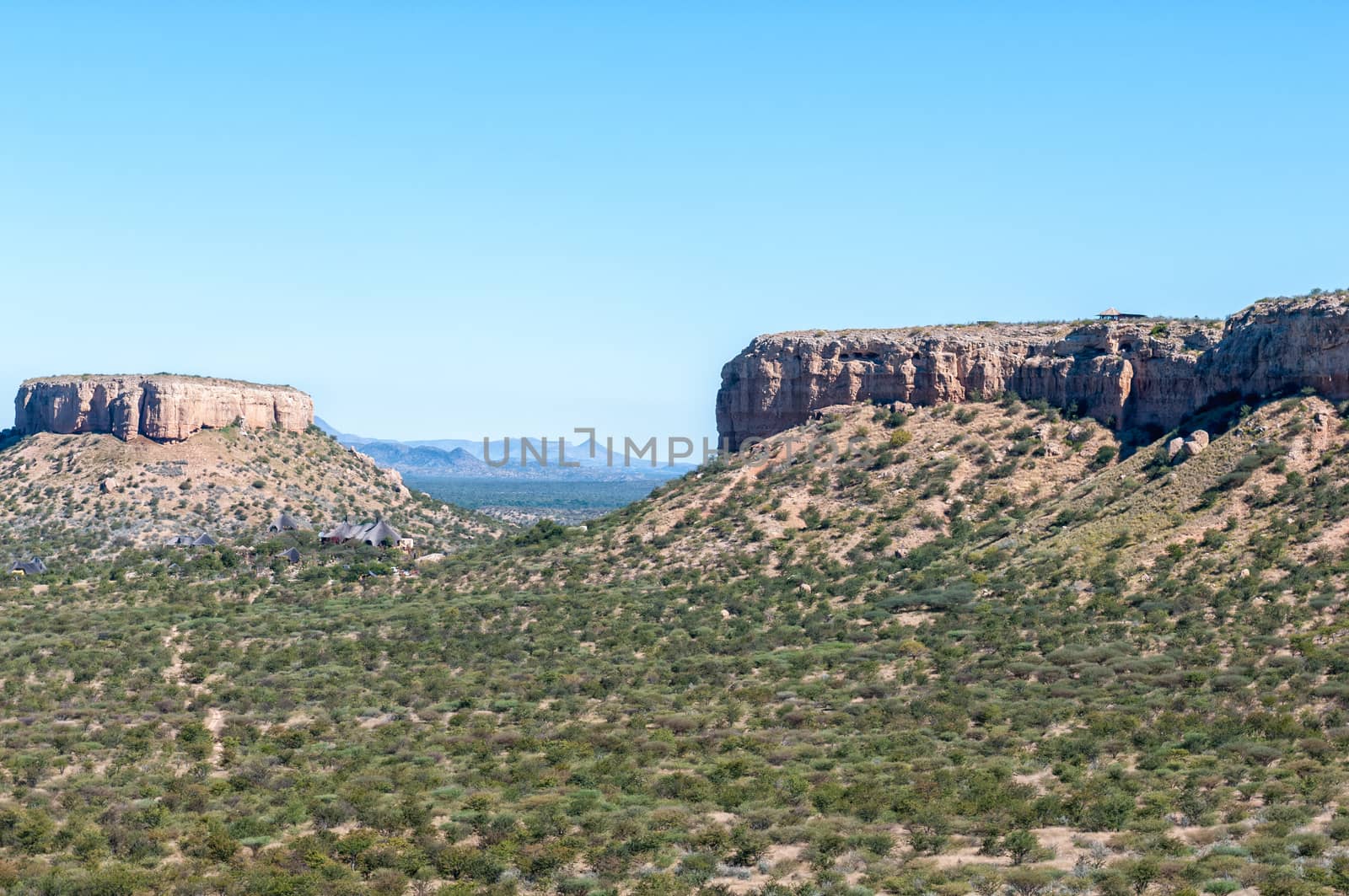 View from the Vingeklip, a sedimentary rock pillar near Outjo in Namibia. The Vingerklip Lodge and the Eagles Nest Restaurant are visible in the back