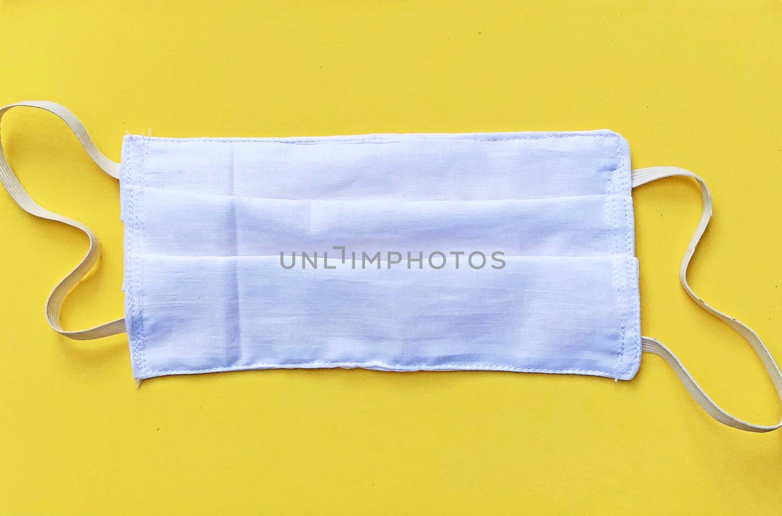 Face mask isolated in the yellow background