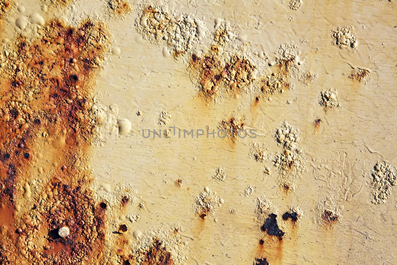 Rust covered weathered iron metal texture background with yellow peeling blistering paint