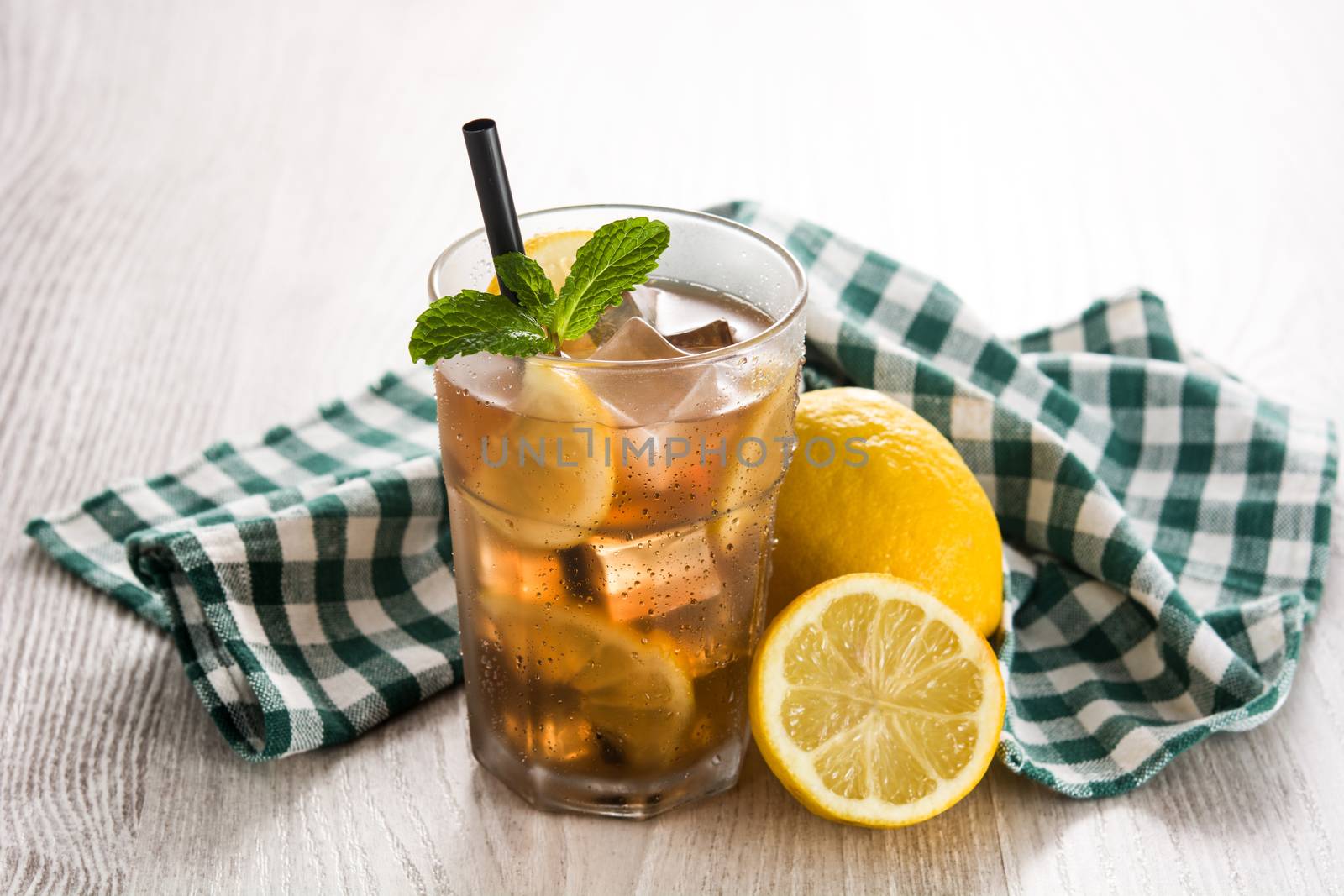Iced tea drink with lemon in glass by chandlervid85