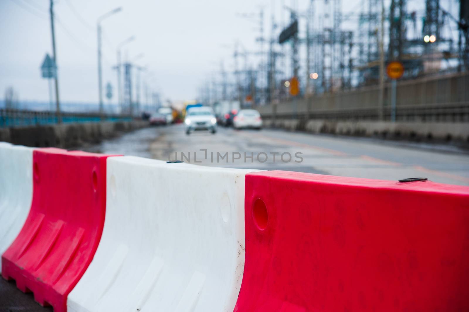 Orange construction light on barricade and red safety barriers o by grigorenko