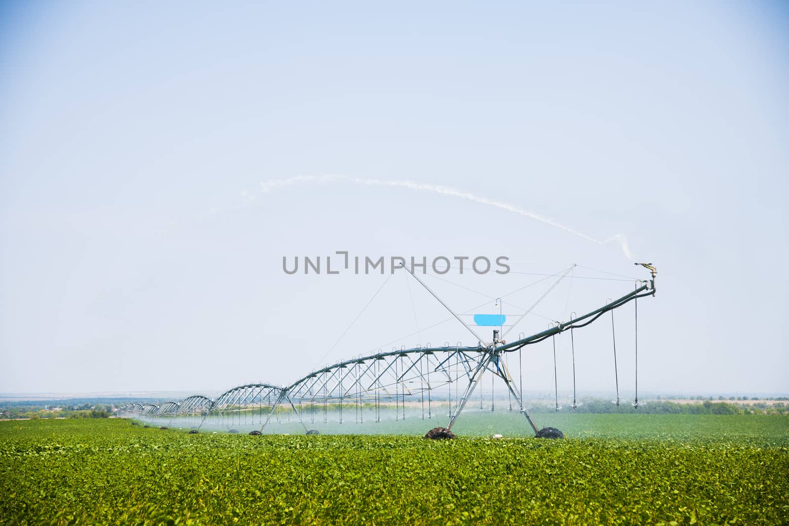 Automated farming irrigation sprinklers system on cultivated agricultural landscape field