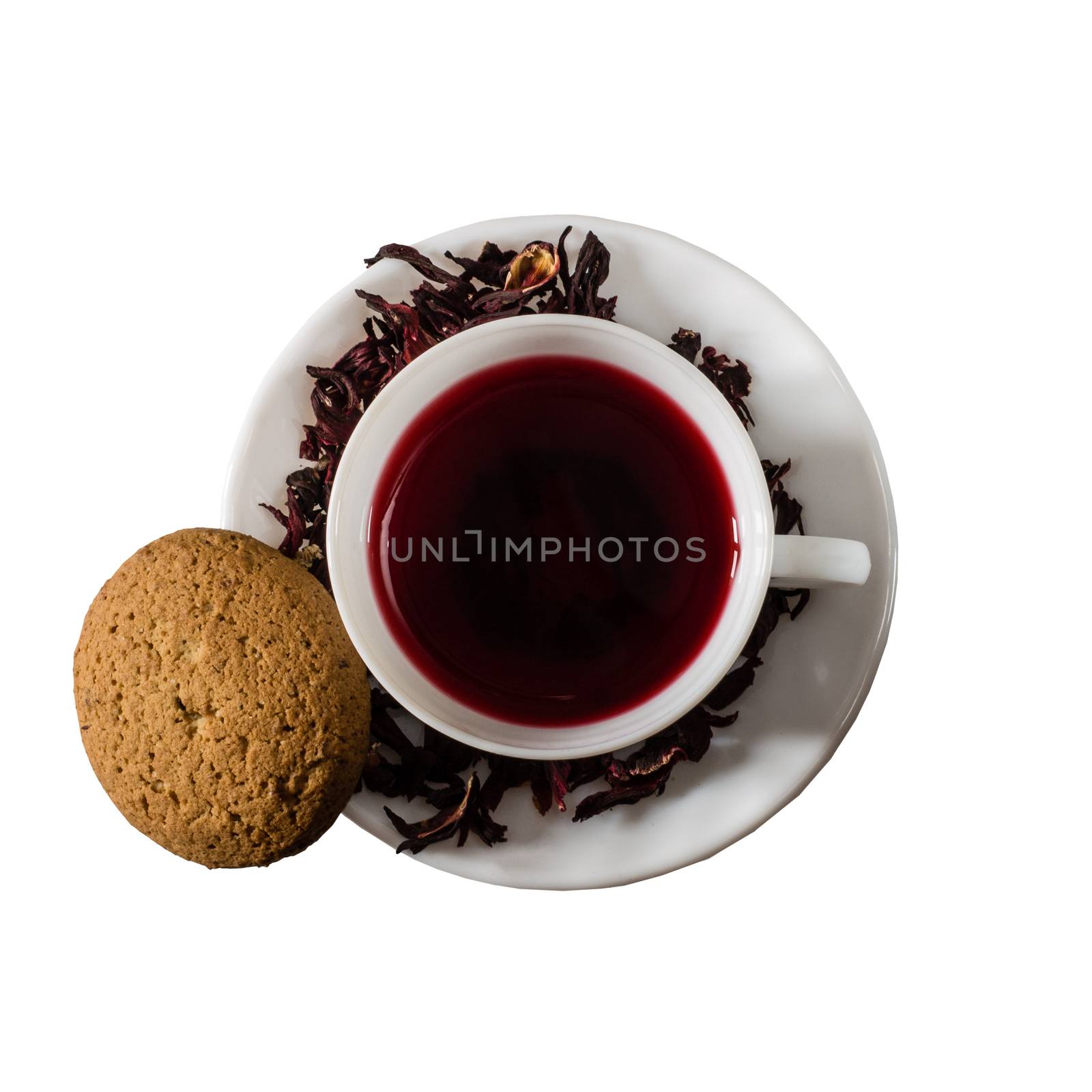 Cup of Karkadeh Red Tea with Dry Flowers and cookies isolated on a white background