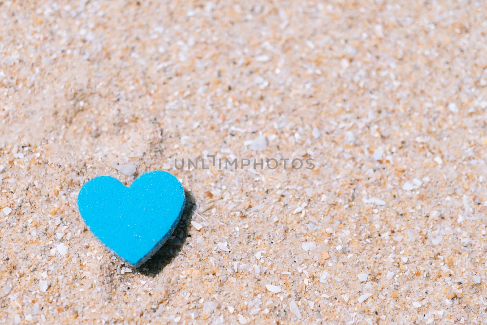 Heart shape on sand at summer beach with copy space. Valentine day concept. by Suwant